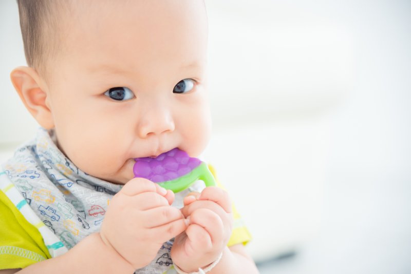 Child teething on a cold toy