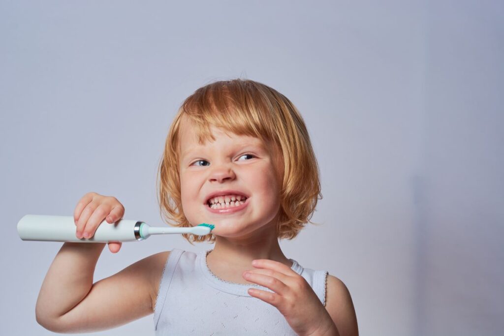 A little girl brushing her teeth